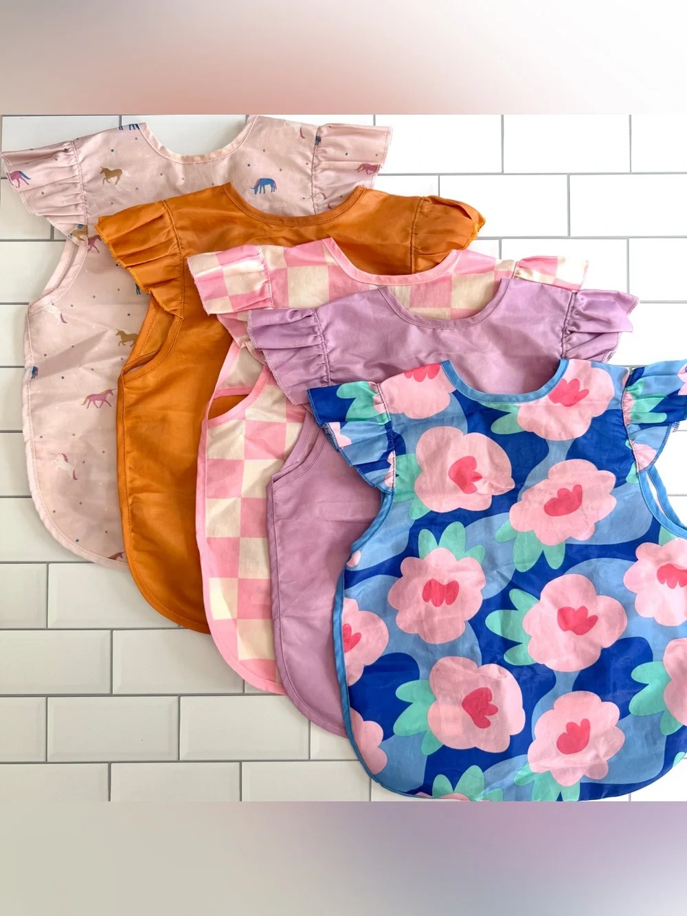 6-24M🫟 Tiny Twinkle 5 Pack Waterproof Ruffle Apron Bibs Solids Floral Checkered